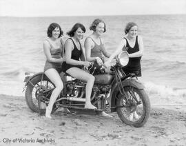 Four woman on a motorcycle on the beach