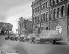 Trucks of Slinger's wine lined up on Johnson Street near Victoria Wineries building at 1400 Store Street