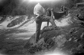 Lowering canoe over rocks