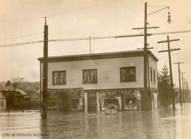 Flooded stores at the N.W. corner of Belmont Road and Haultain Street during a January flood