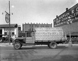 Trucks of Slinger's wine lined up on Johnson Street near Victoria Wineries building at 1400 Store Street