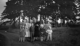 McDonald family and friends wearing hats near a forest