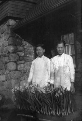 Wee and Chew, two of the Rattenbury's household staff, with flower planters at 1701 Beach Drive