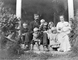 Laurence family on the front steps of their home.  They had the most northern wheat field in North America