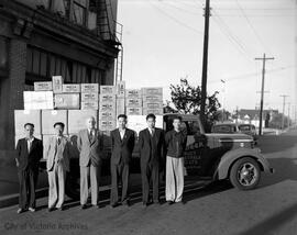 Men standing in front of delivery truck