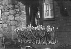 Florence at the door of 1701 Beach Drive next to flower planters