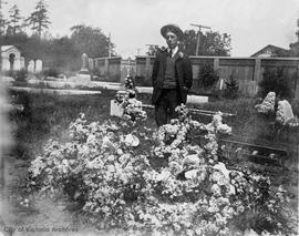 Richard Muirhead beside family grave in Ross Bay Cemetery