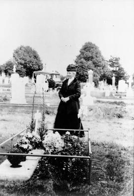 Woman beside grave