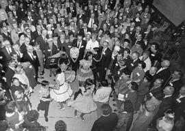 Large group of people watching an exhibition of square dancing