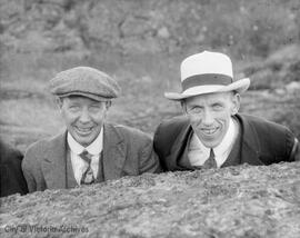 Two men wearing hats