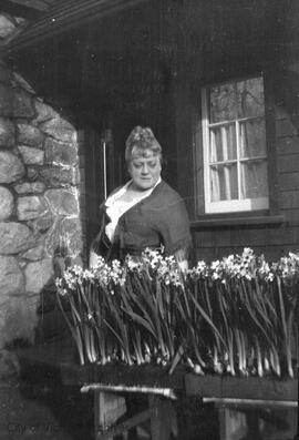 Florence Rattenbury with flower planters at 1701 Beach Drive