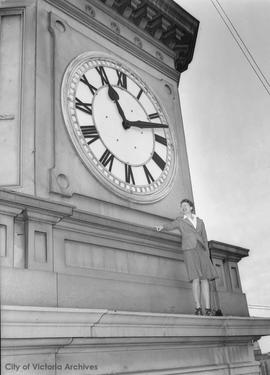 Miss Margaret Scott, secretary to City Solicitor, next to City Hall clock tower