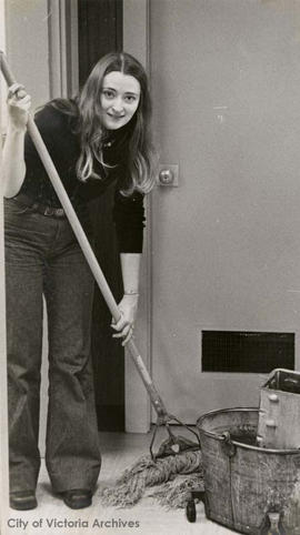 City Archives employee, Linda Eversole, washing the Archives' floor at 613 Pandora Avenue